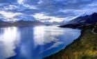 lake surrounded by snow-capped mountains
